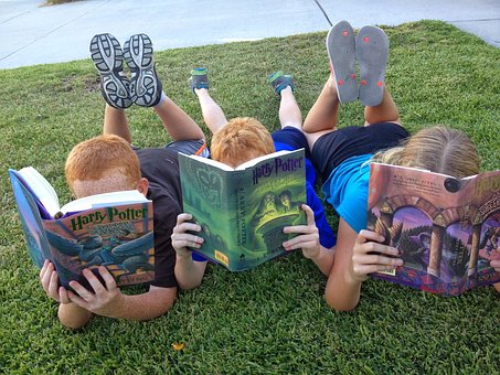 kids reading on grass